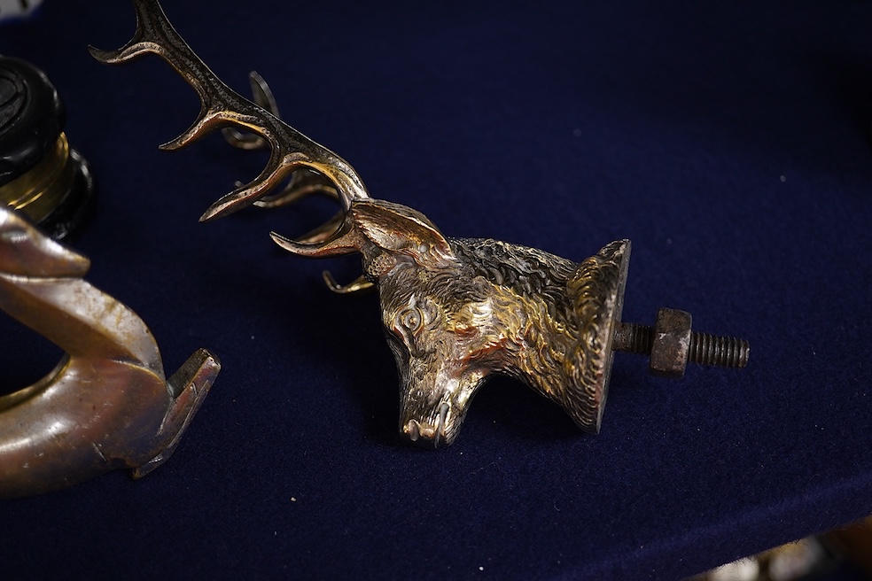 Five chrome and brass car radiator mascots; three in the form of stags’ heads, a stag standing on an oak branch and an Art Deco leading gazelle. Condition - fair, some losses to chrome plating.